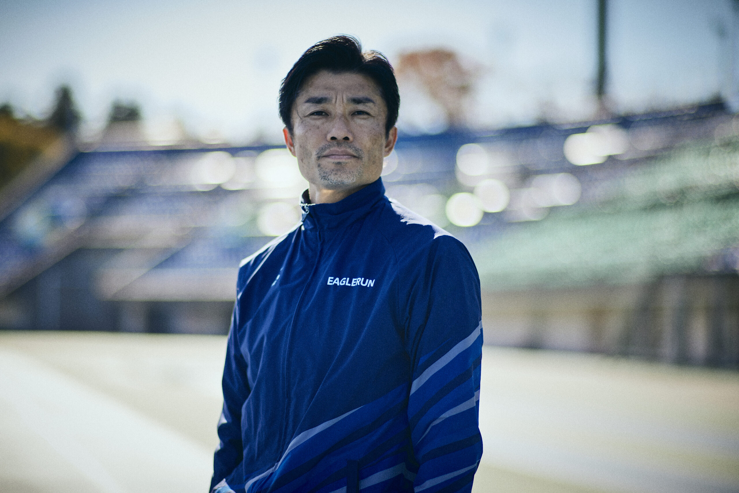 A photo of Suetsugu standing on the track looking at us.